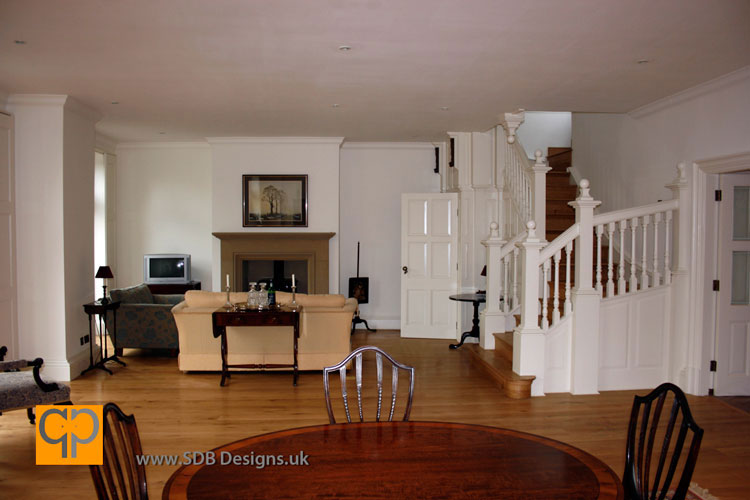 A picture of a beautiful white staircase with bullnosed oak treads and risers accompanied with secret nailed natural English oak polished flooring by 
 SDB Designs designed by Sean Broadbent